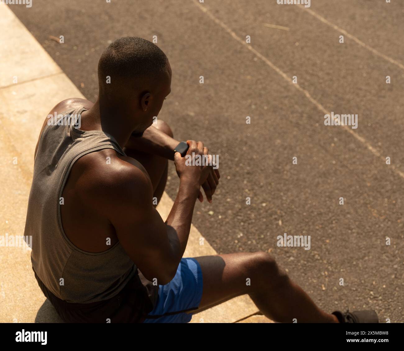 Athletic man looking at smart watch Stock Photo