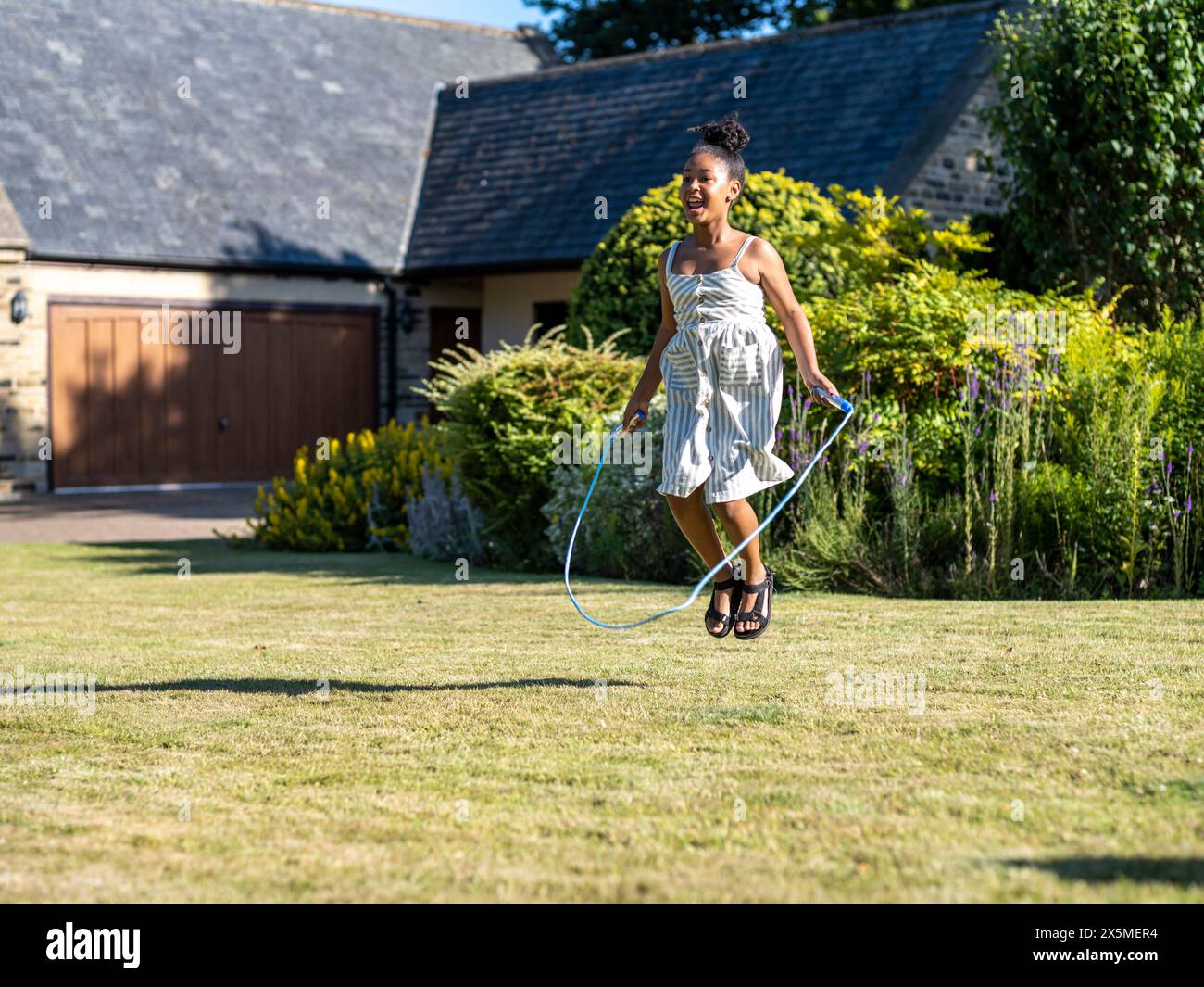 Child jumping rope hi-res stock photography and images - Alamy