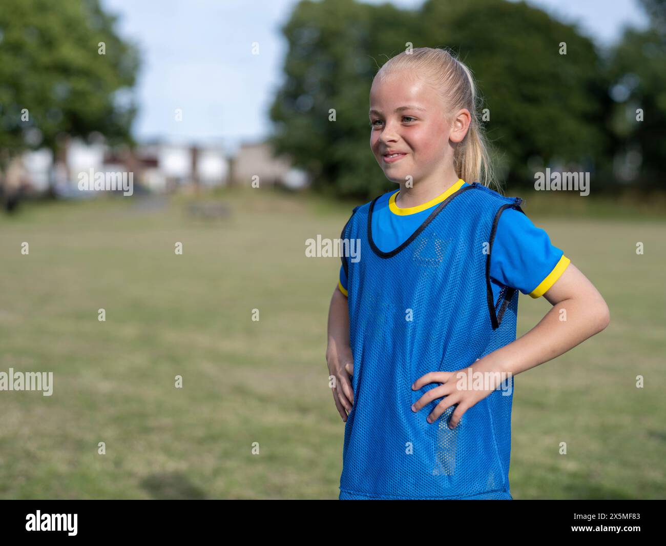 Girl (8-9) dressed in soccer uniform Stock Photo