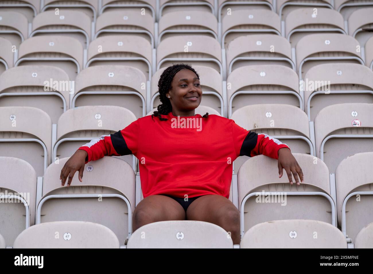 Black woman sitting on chair hi-res stock photography and images - Alamy