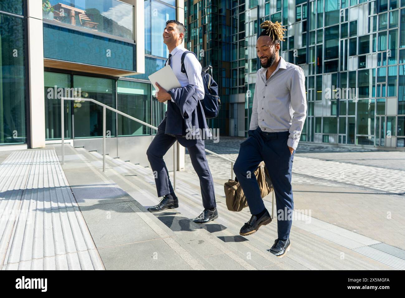 Two businessmen walking in business district Stock Photo - Alamy