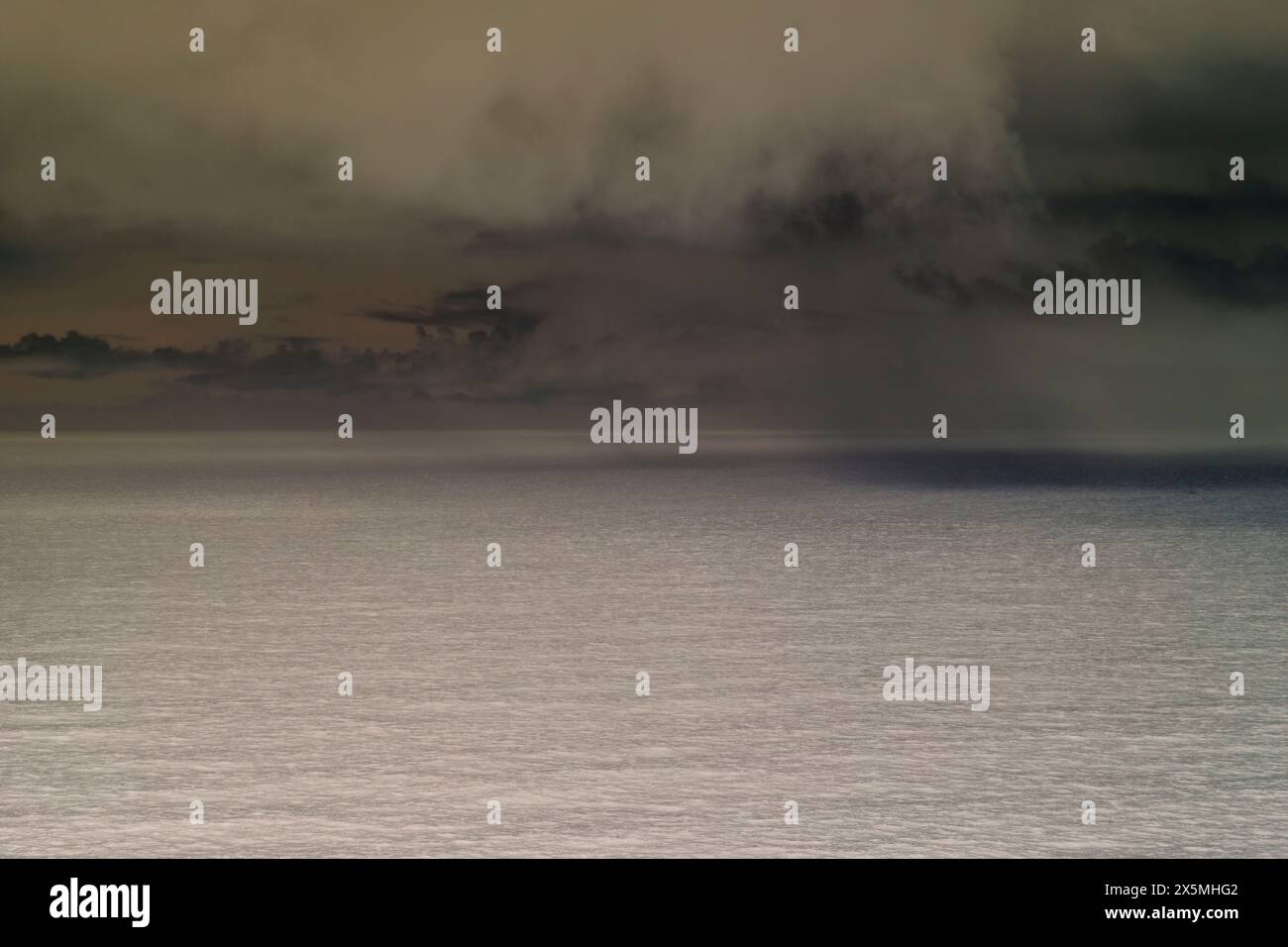 Abstract of clearing storm over vast ocean at dusk, Oregon Stock Photo