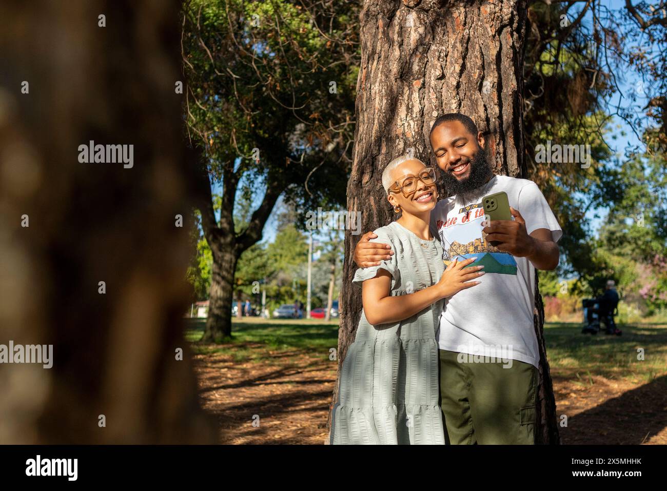 Couple taking selfie in park Stock Photo