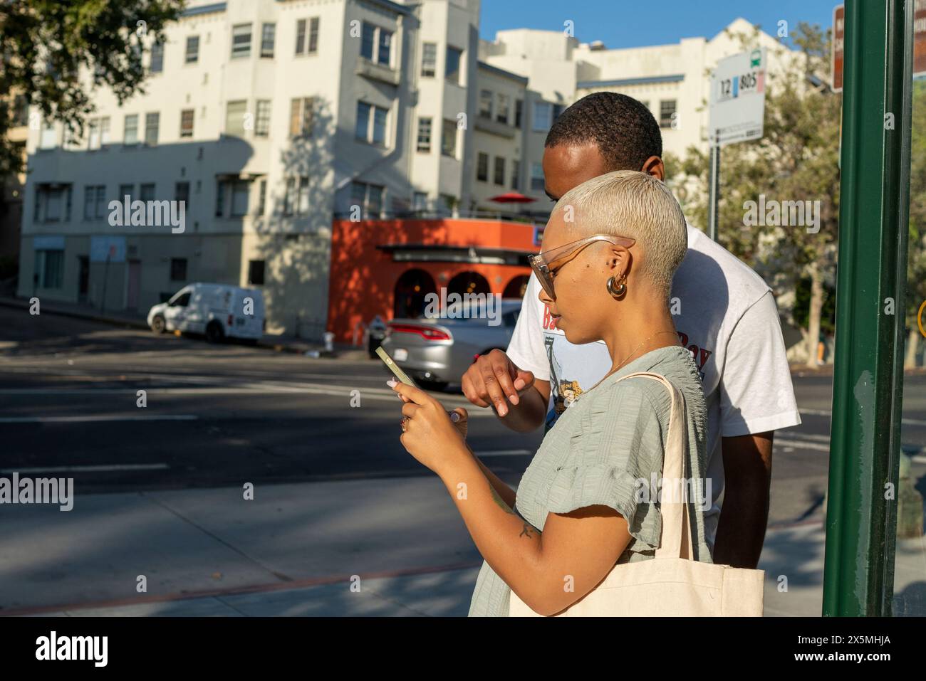 Young couple using smart phone in city Stock Photo
