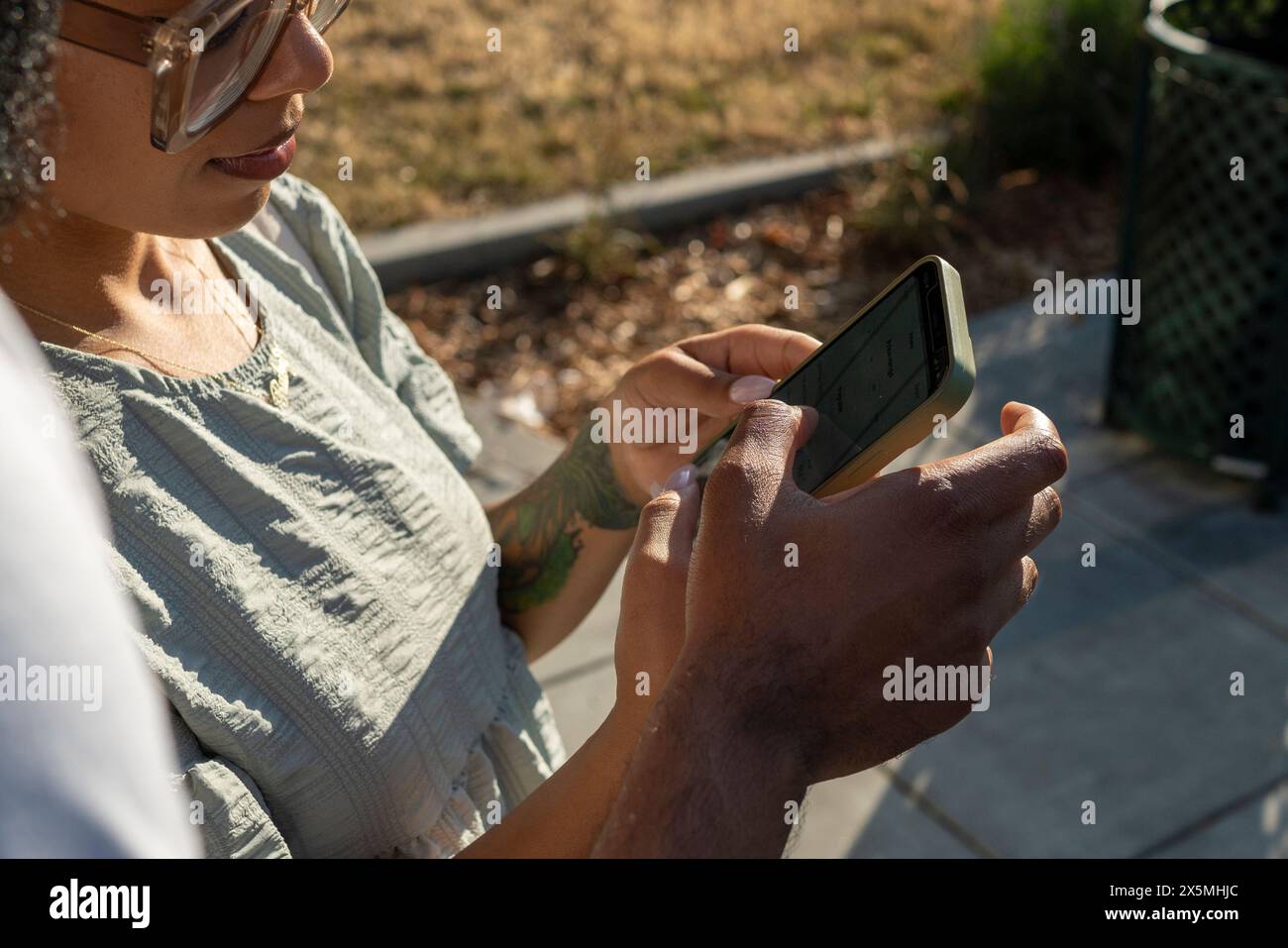 Young couple using smart phone in city Stock Photo