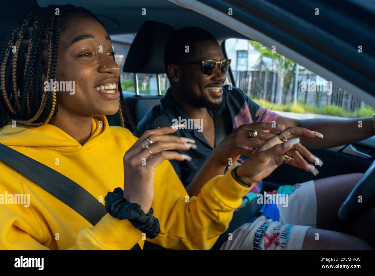 Couple singing in car on road trip Stock Photo - Alamy