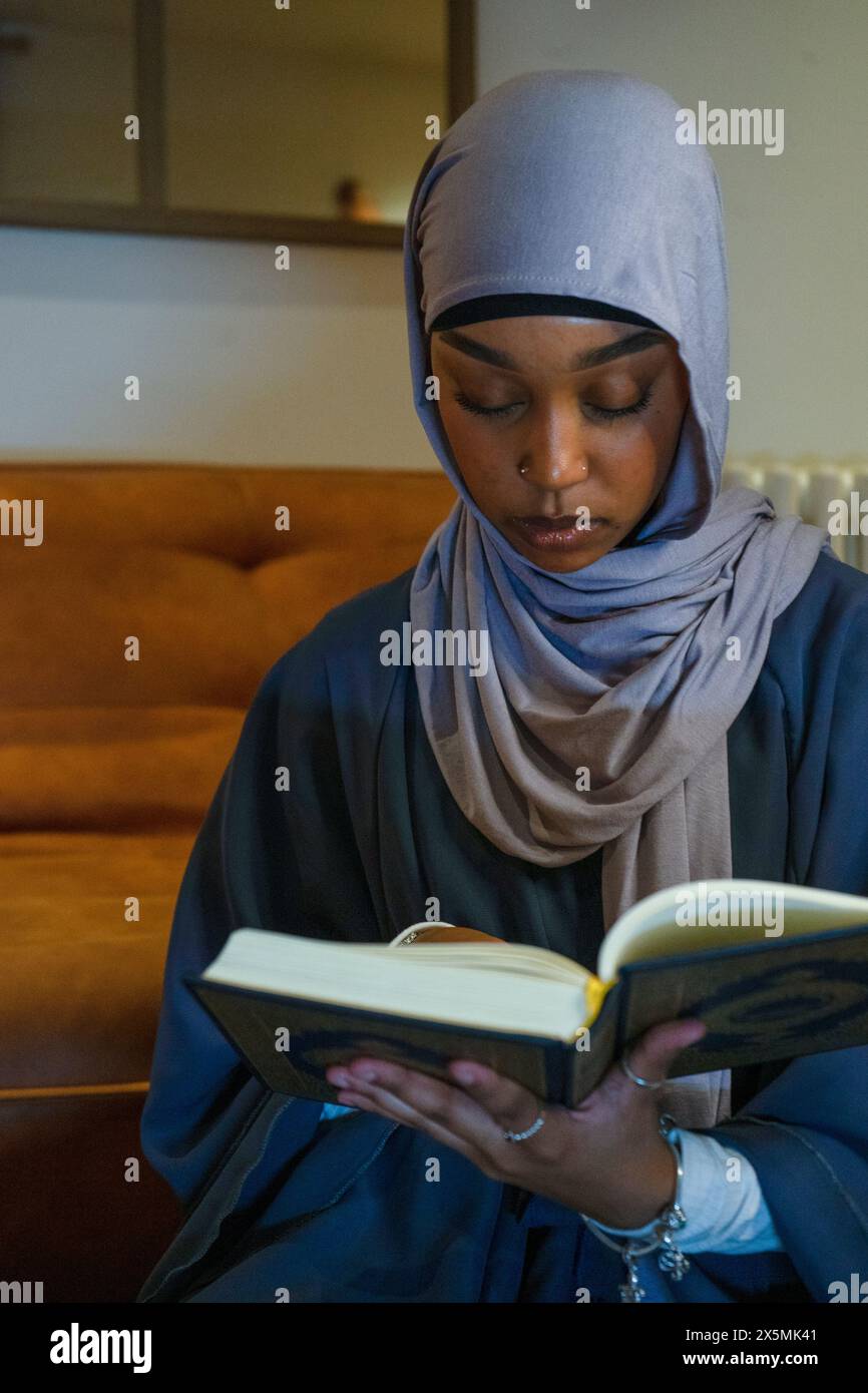 Muslim woman praying at home Stock Photo