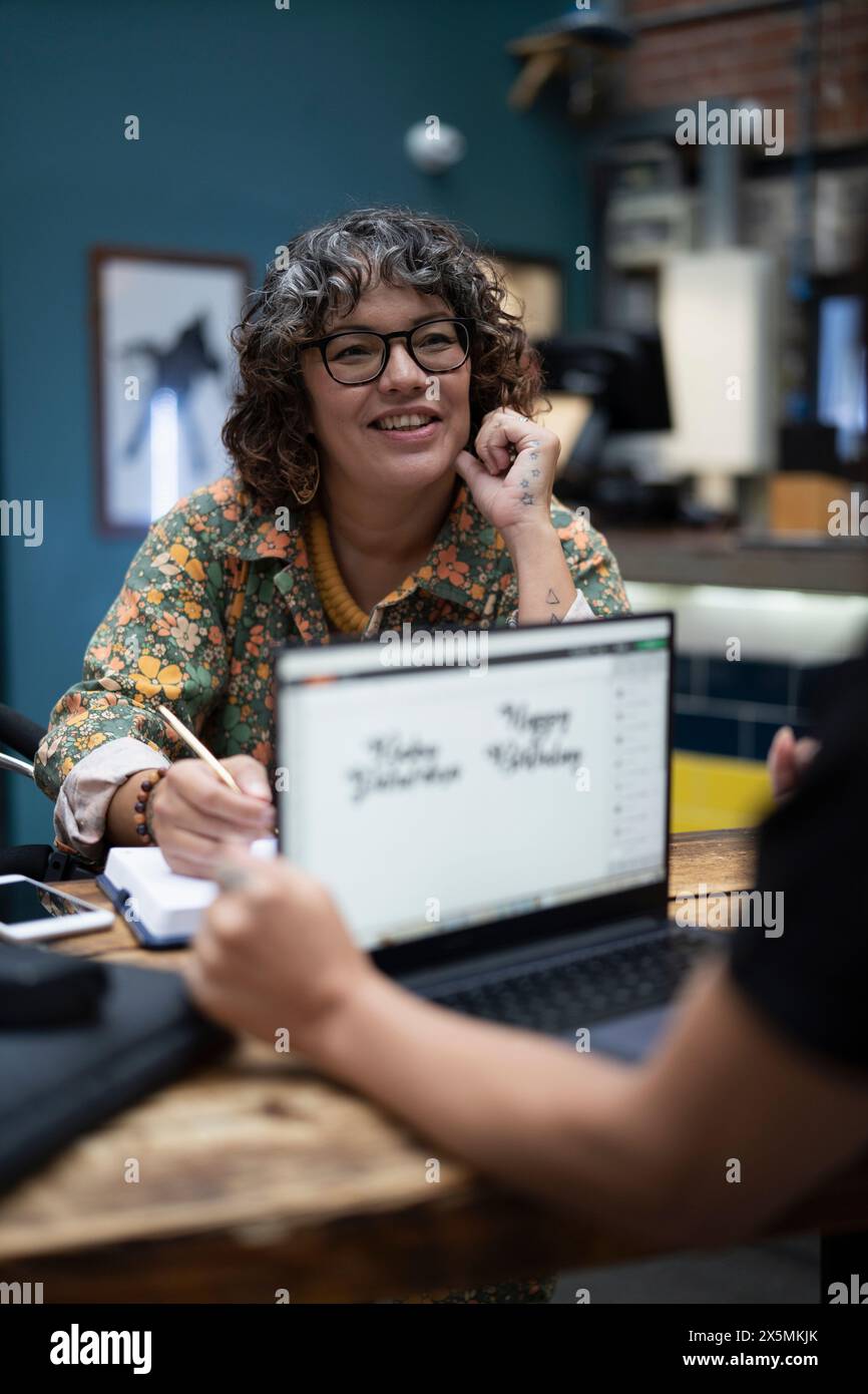 Creative professionals working together in cafeteria Stock Photo