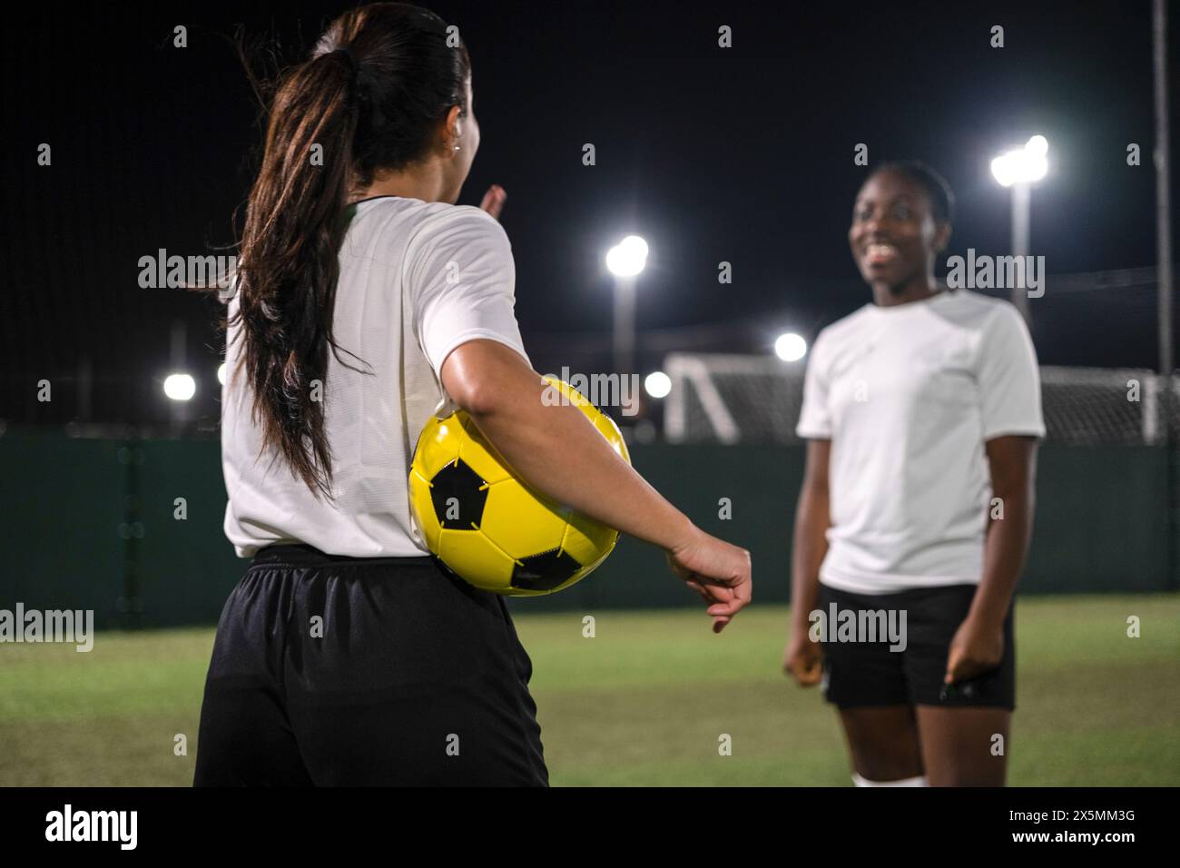 Female soccer players in playing field Stock Photo
