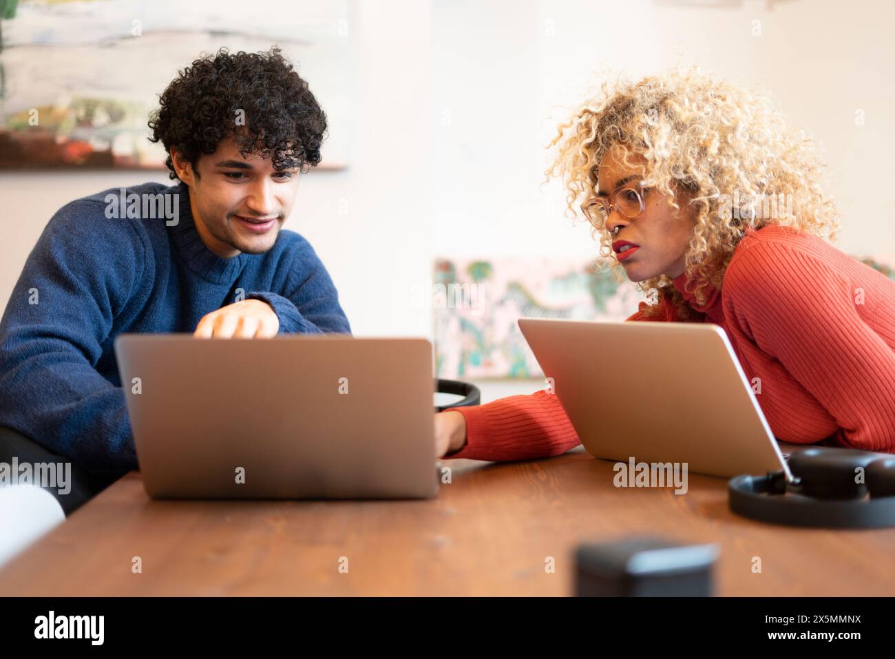 Creative professionals working on laptops in office Stock Photo