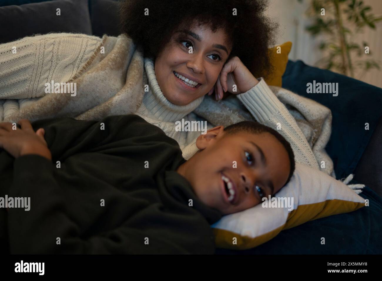Mother and son lying on sofa Stock Photo