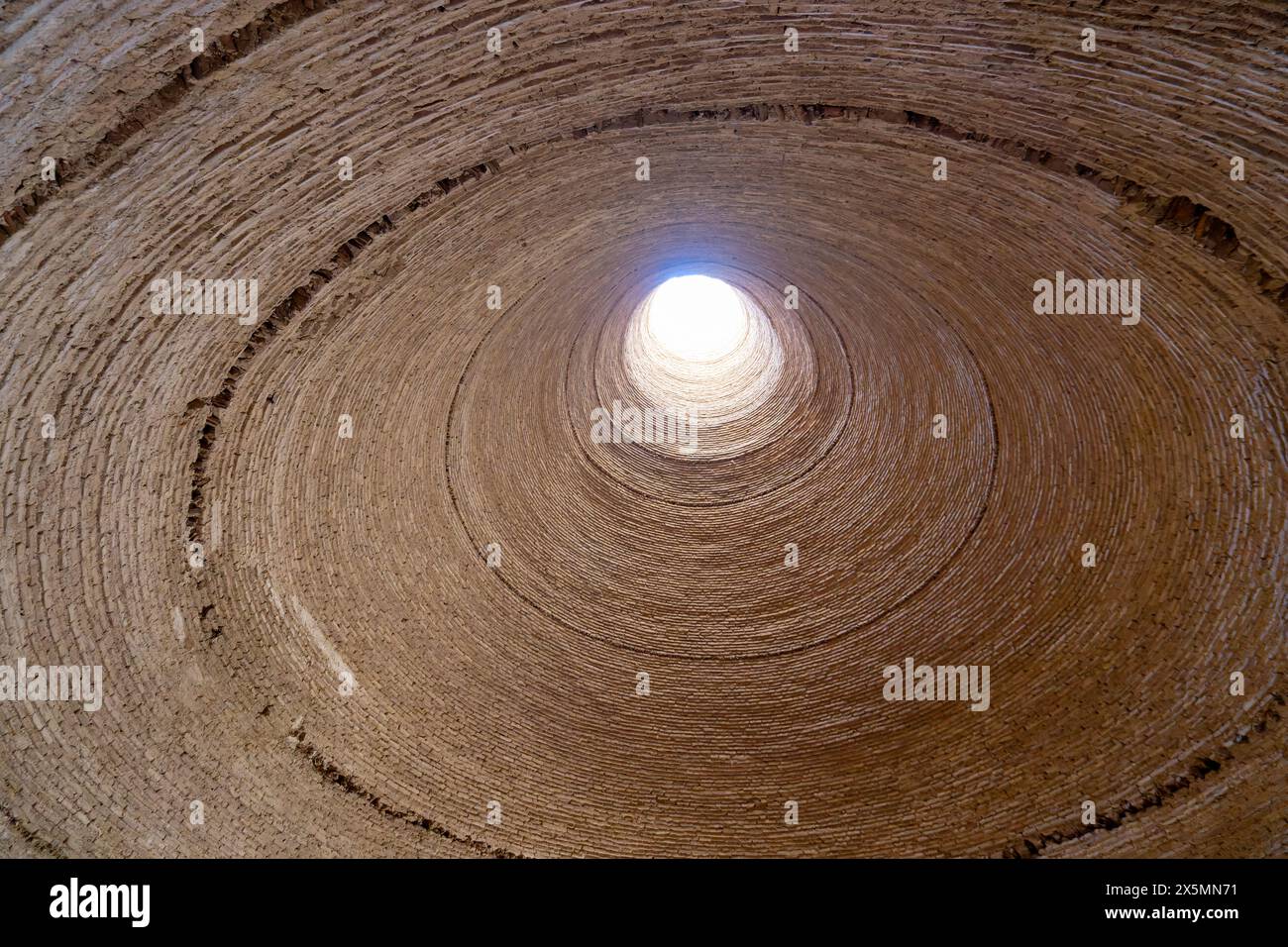 Inside the historic Yakhchal, sunlight streams in through the top opening. This is a testament to ancient Persian cooling technology. Yazd, Iran. Stock Photo