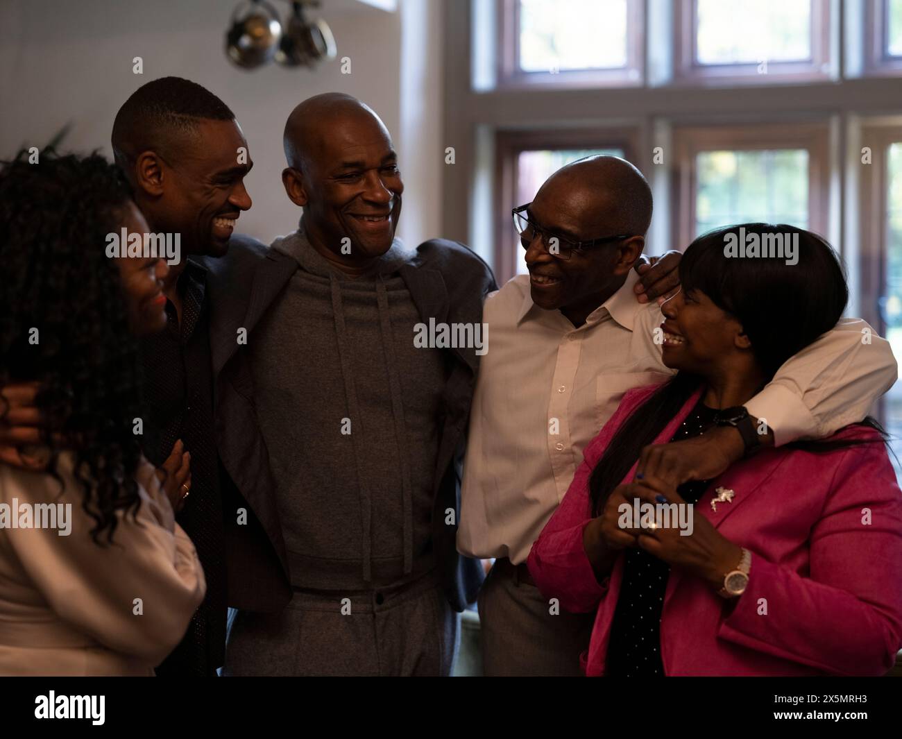 Smiling family embracing hi-res stock photography and images - Alamy