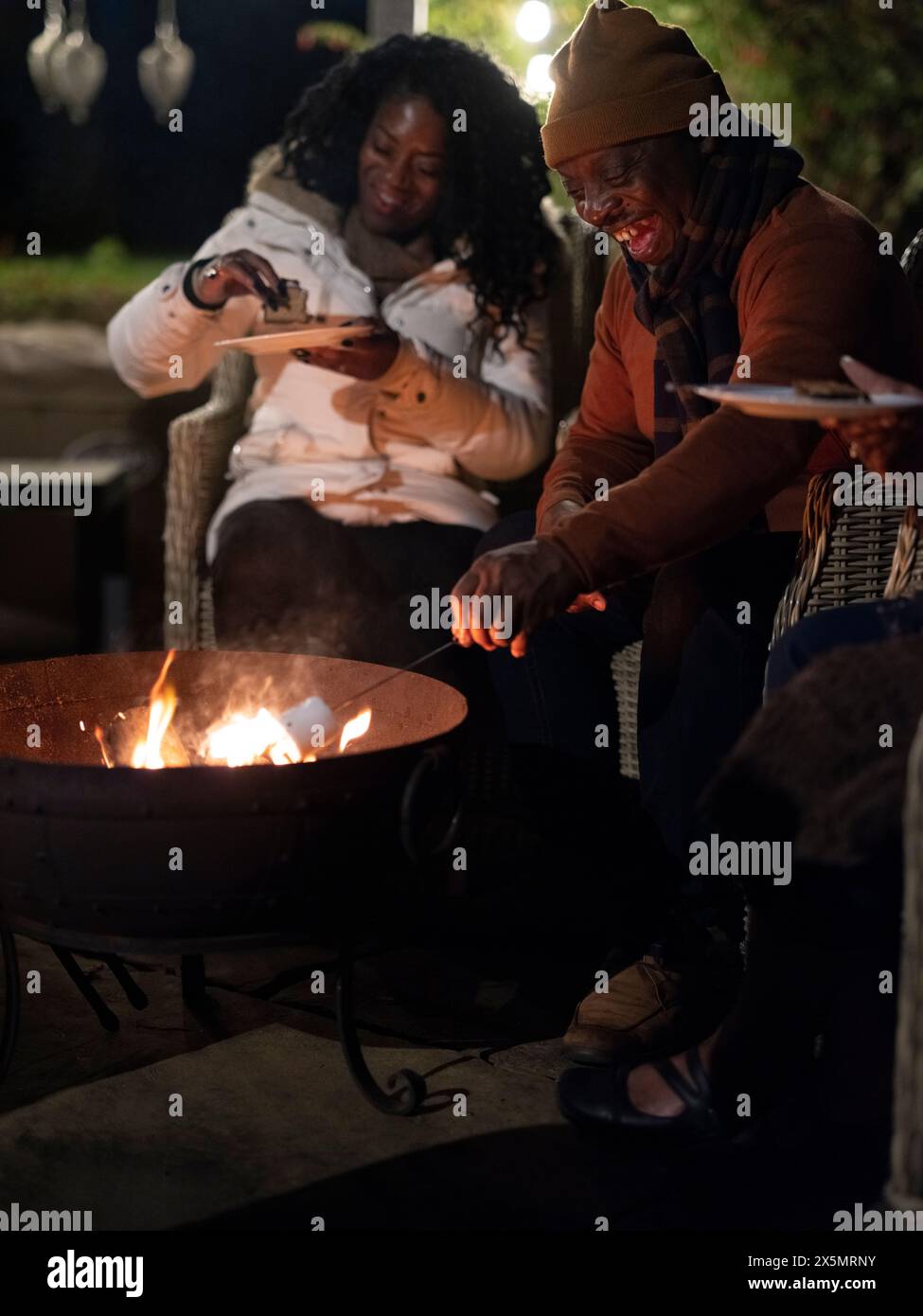 Family roasting marshmallows in fire pit Stock Photo - Alamy