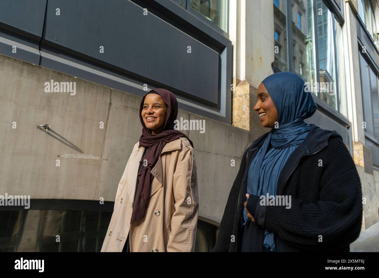 Two women walking and street hi-res stock photography and images - Alamy