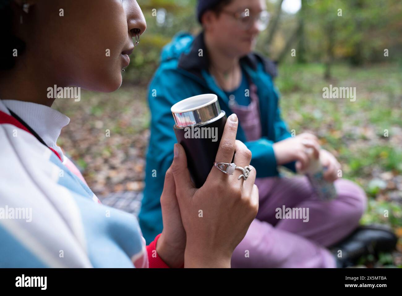 Women drinking from insulated drink containers while camping Stock ...