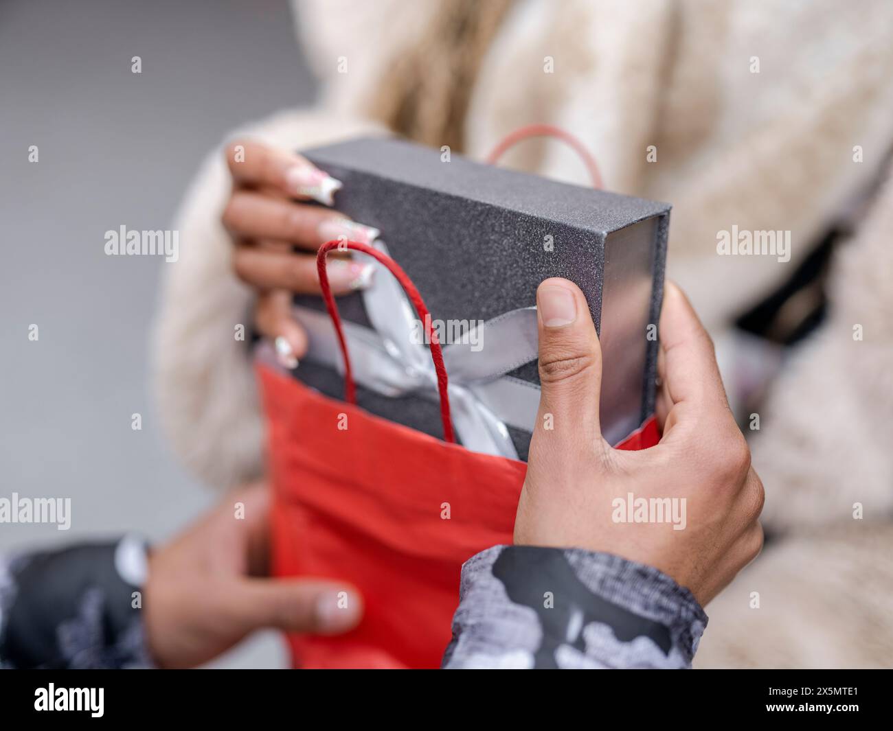 Man Giving Girlfriend Christmas Present Stock Photo Alamy