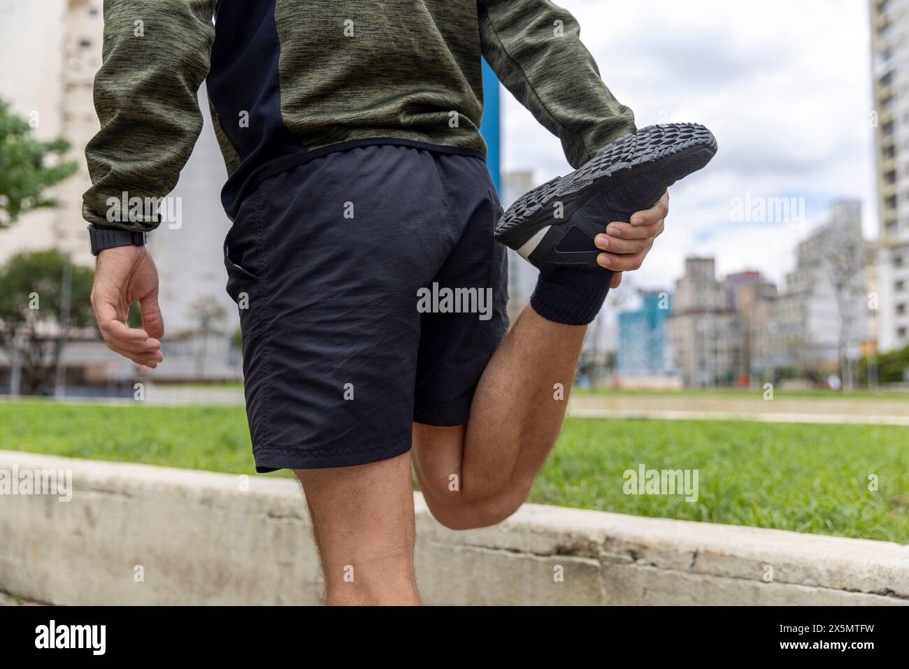 Young man stretching leg on hi-res stock photography and images - Alamy