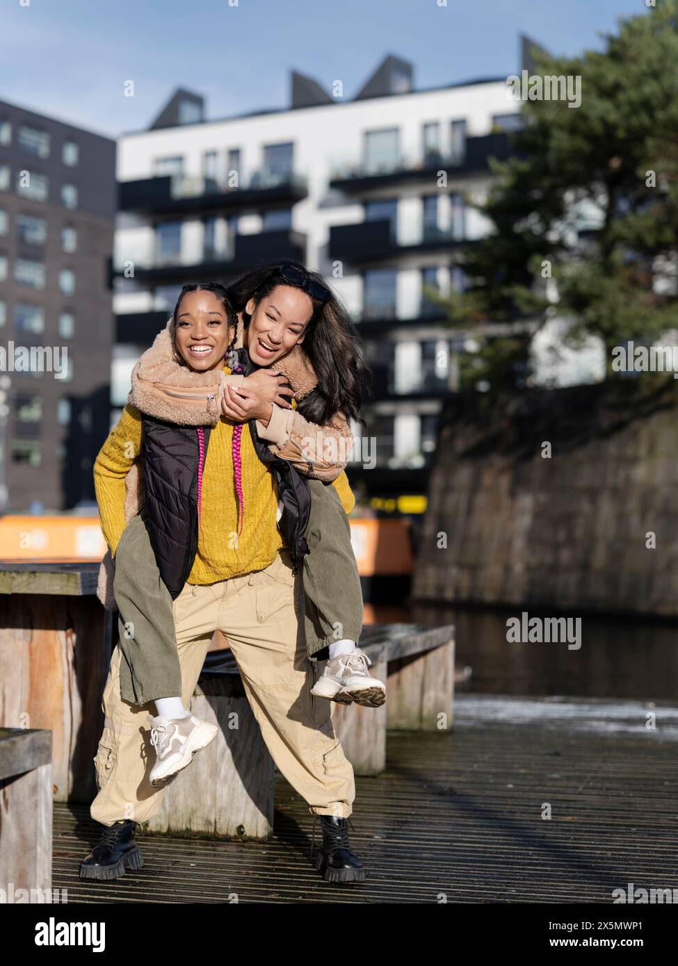 Young woman giving friend piggyback hi-res stock photography and images ...