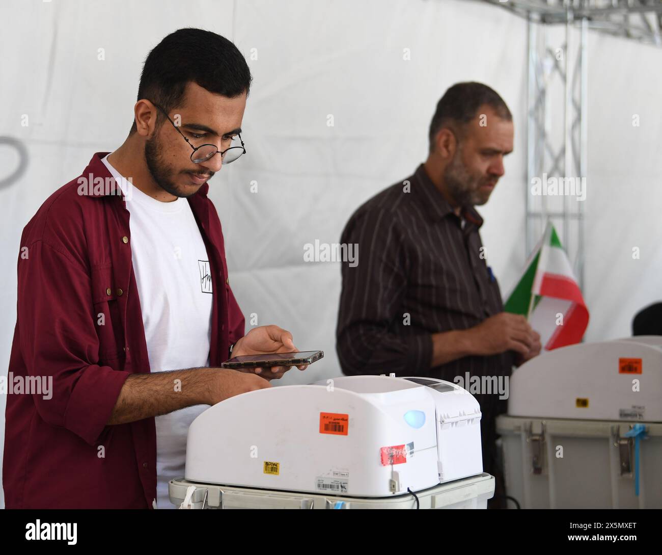 Tehran, Iran. 10th May, 2024. People vote during the second round of Iran's 12th parliamentary election in Tehran, Iran, May 10, 2024. Credit: Shadati/Xinhua/Alamy Live News Stock Photo