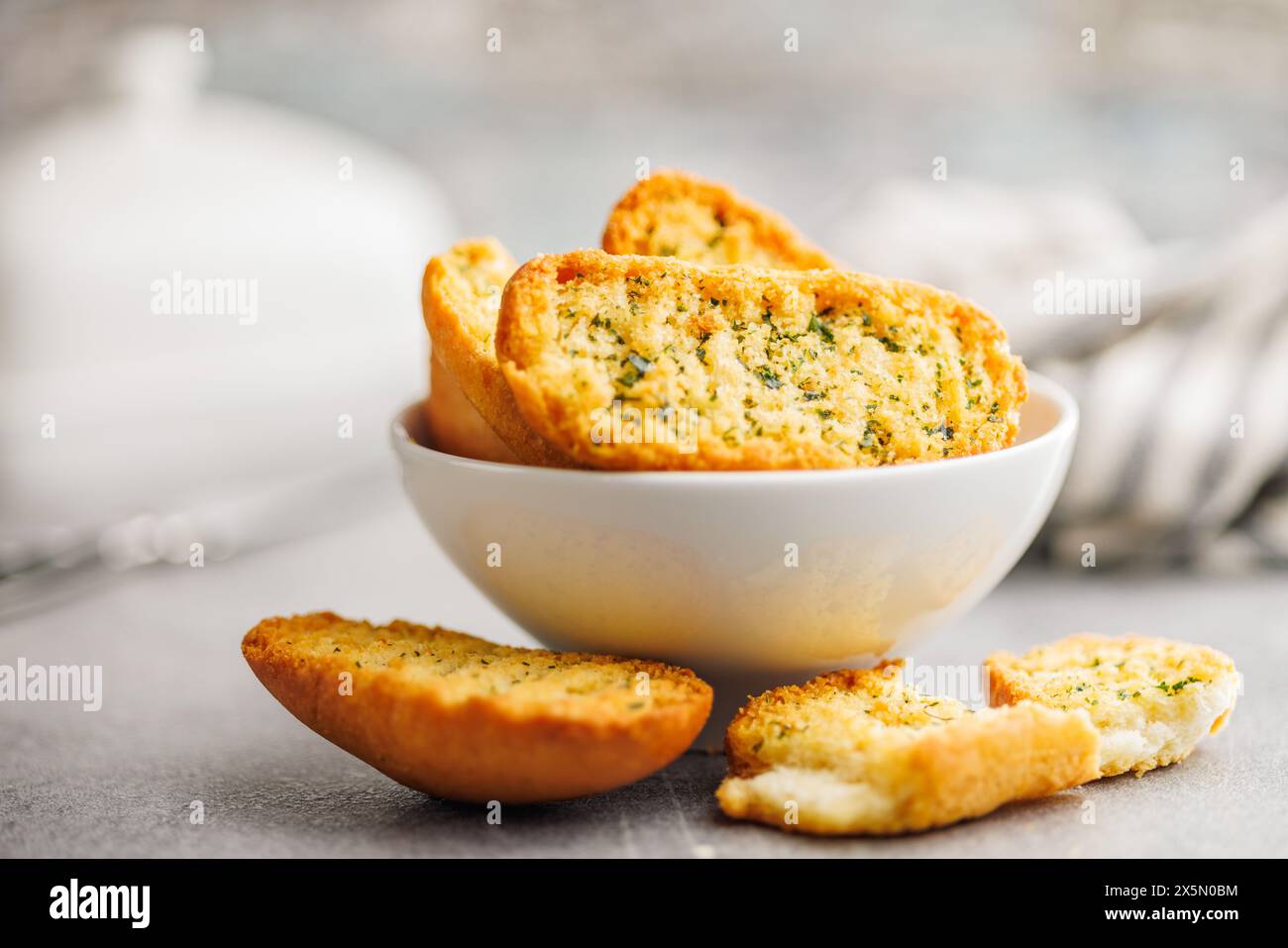 Garlic crisp bread Slices Topped With Herbs in a bowl. Stock Photo