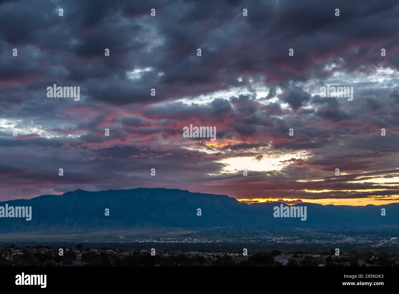 USA, New Mexico, Sandia Mountains. Cloudy sunrise over Albuquerque. Stock Photo