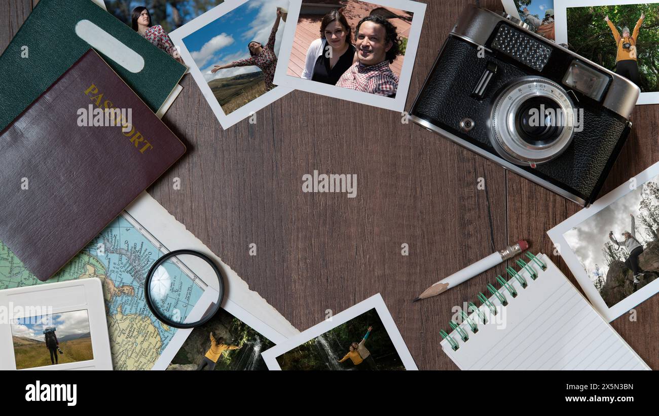 Top view of Couple photographs, passports, old camera, map and notebook on a dark wooden table Stock Photo