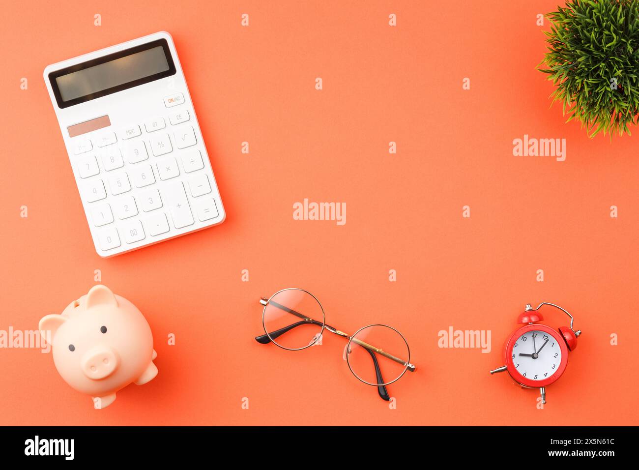 Piggy bank with calculators office desk top view. Stock Photo