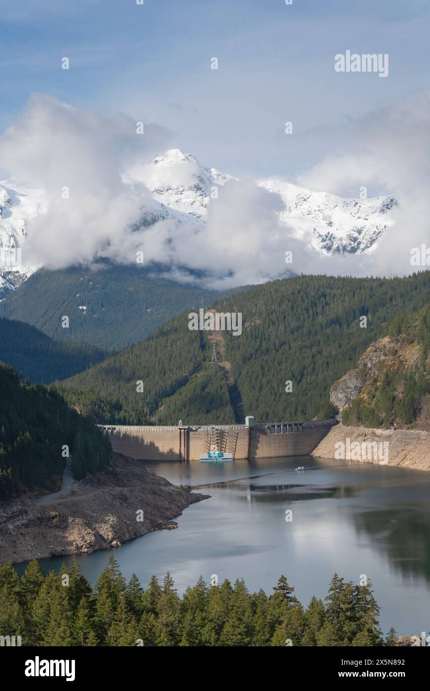 Ross Dam and Ross Lake during spring drawdown. Pyramid Peak is in the distance. Ross Lake National Recreation Area, North Cascades, Washington State. Stock Photo