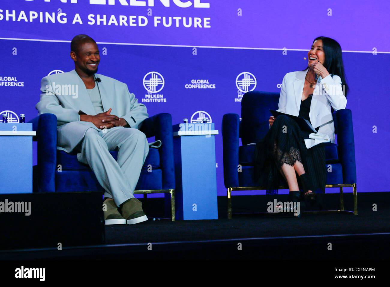 Beverly Hills, CA C May 8th, 2024 C Usher grins as Lisa Ling smiles at