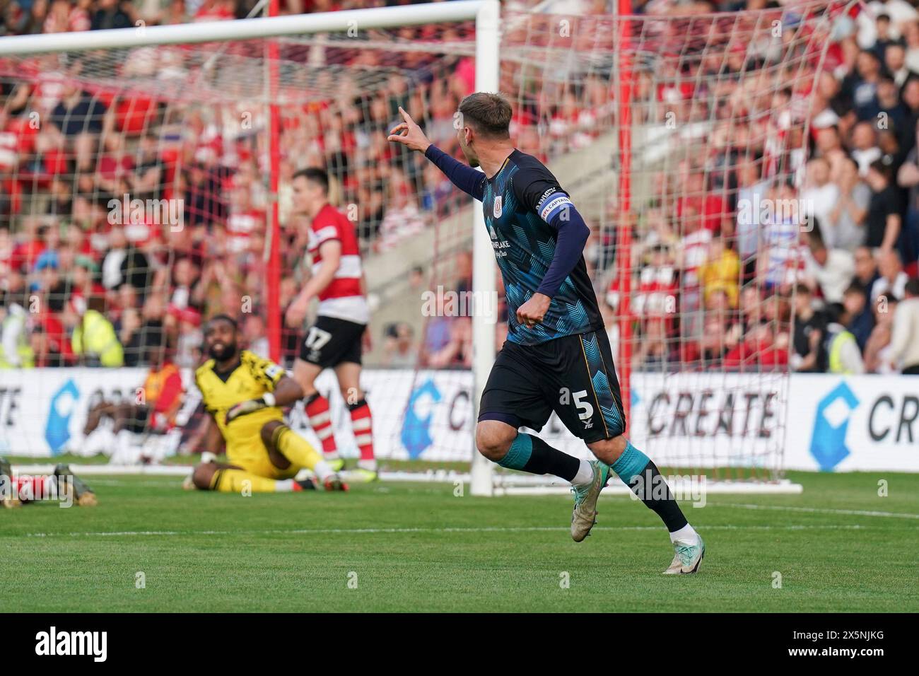 Crewe Alexandra defender Mickey Demetriou (5) scores a GOAL 01 and