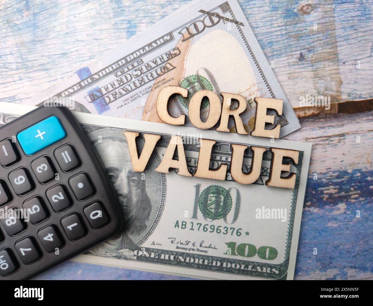 Too view calculator,banknotes and wooden word with text CORE VALUE on wooden background. Business concept. Stock Photo
