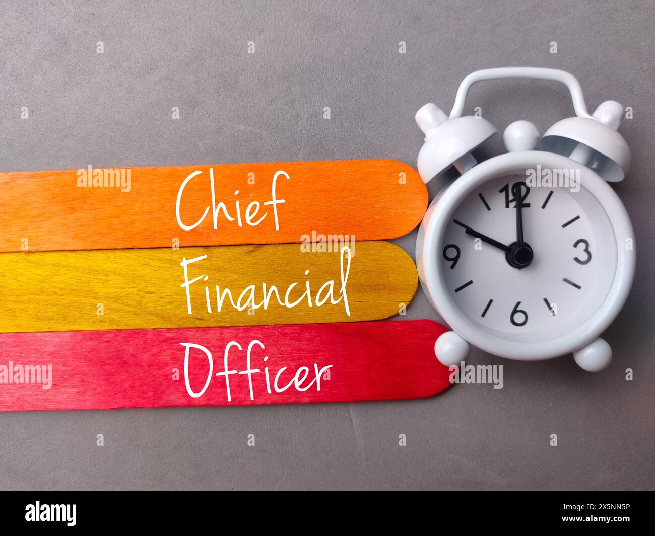 Top view colored ice cream stick and clock with text Chief Financial ...