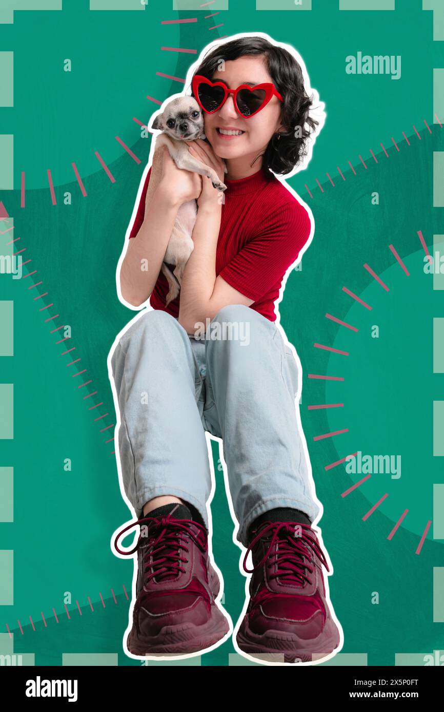 Young girl is sitting, she holds her pet chihuahua dog, pose for photo, very colorful green background, ideal for social media banner. copy space Stock Photo