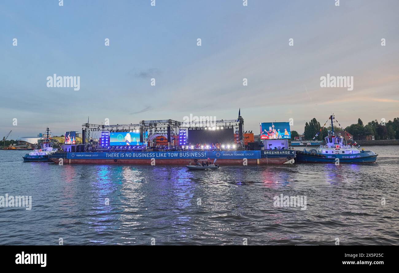 Hamburg, Germany. 10th May, 2024. Musical actors from Disney's 'The Lion King' perform on a floating show stage in the harbor on the Elbe during the 835th Hamburg Harbor Birthday. Credit: Georg Wendt/dpa/Alamy Live News Stock Photo