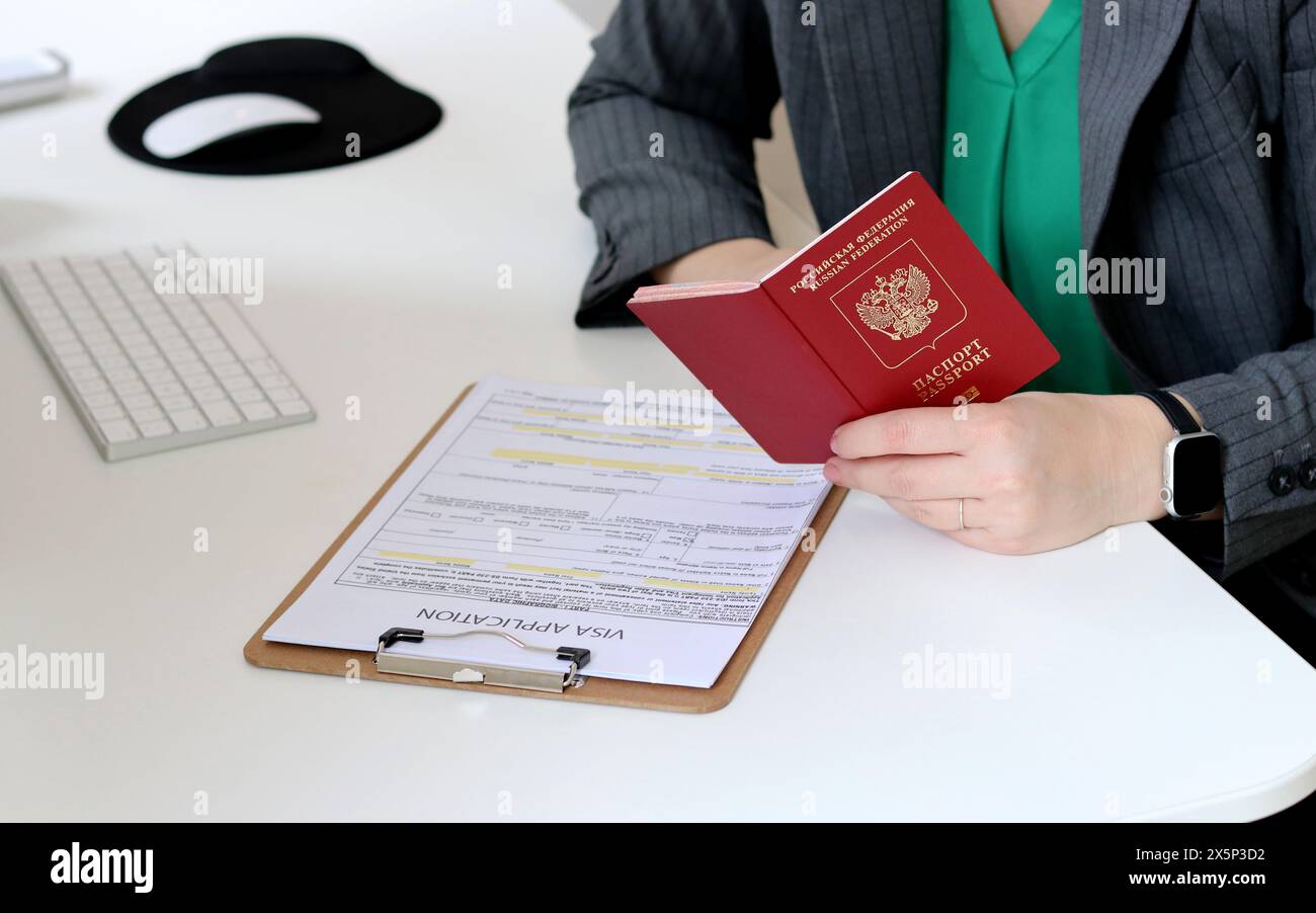 Top view close up of a caucasian woman filling out visa application ...