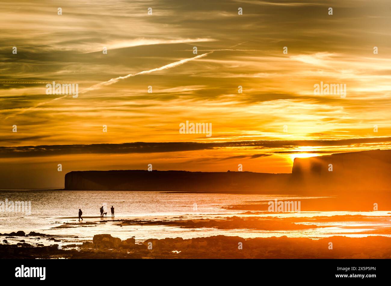 Birling Gap, Eastbourne, East Sussex, UK. 10th May, 2024. End of another glorious warm day on the South Coast as the sun dips beyond the Seven Sisters cliffs creating spectacular colours in the cloudy sky. Credit: David Burr/Alamy Live News Stock Photo