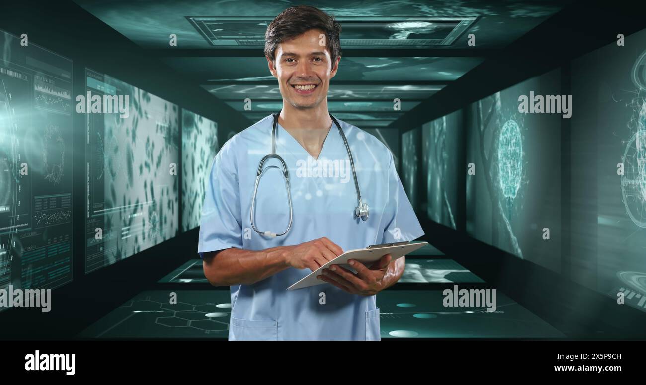 Caucasian male doctor holding tablet in high-tech room Stock Photo