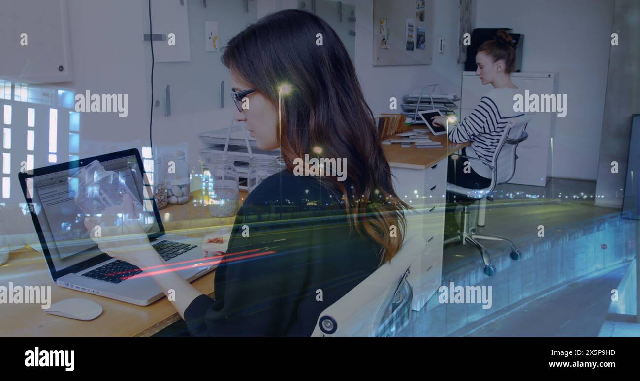 Two Caucasian women, friends, are working on laptops in office Stock Photo