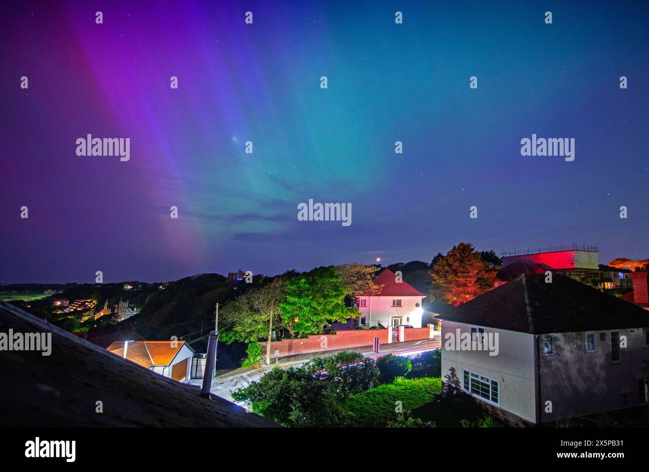 Swansea, UK. 11th May, 2024. The Northern Lights put on a display in the clear night skies above Langland Bay near Swansea tonight. One of the strongest geomagnetic storms for years is currently hitting the earth which increases the chance of seeing the aurora borealis. Credit: Phil Rees/Alamy Live News Stock Photo