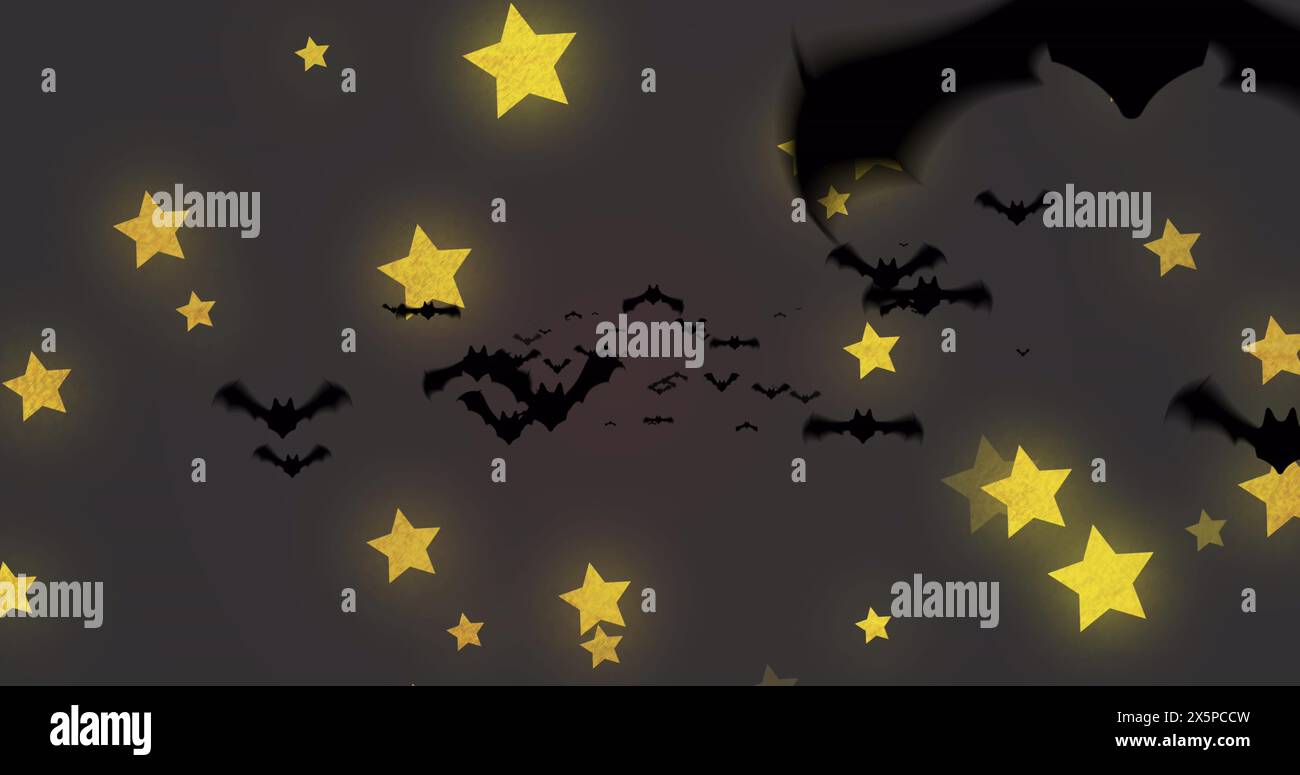 Bats flying among yellow stars against dark background Stock Photo