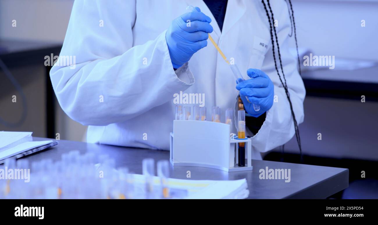 Image of shapes over african american female scientist in lab Stock Photo