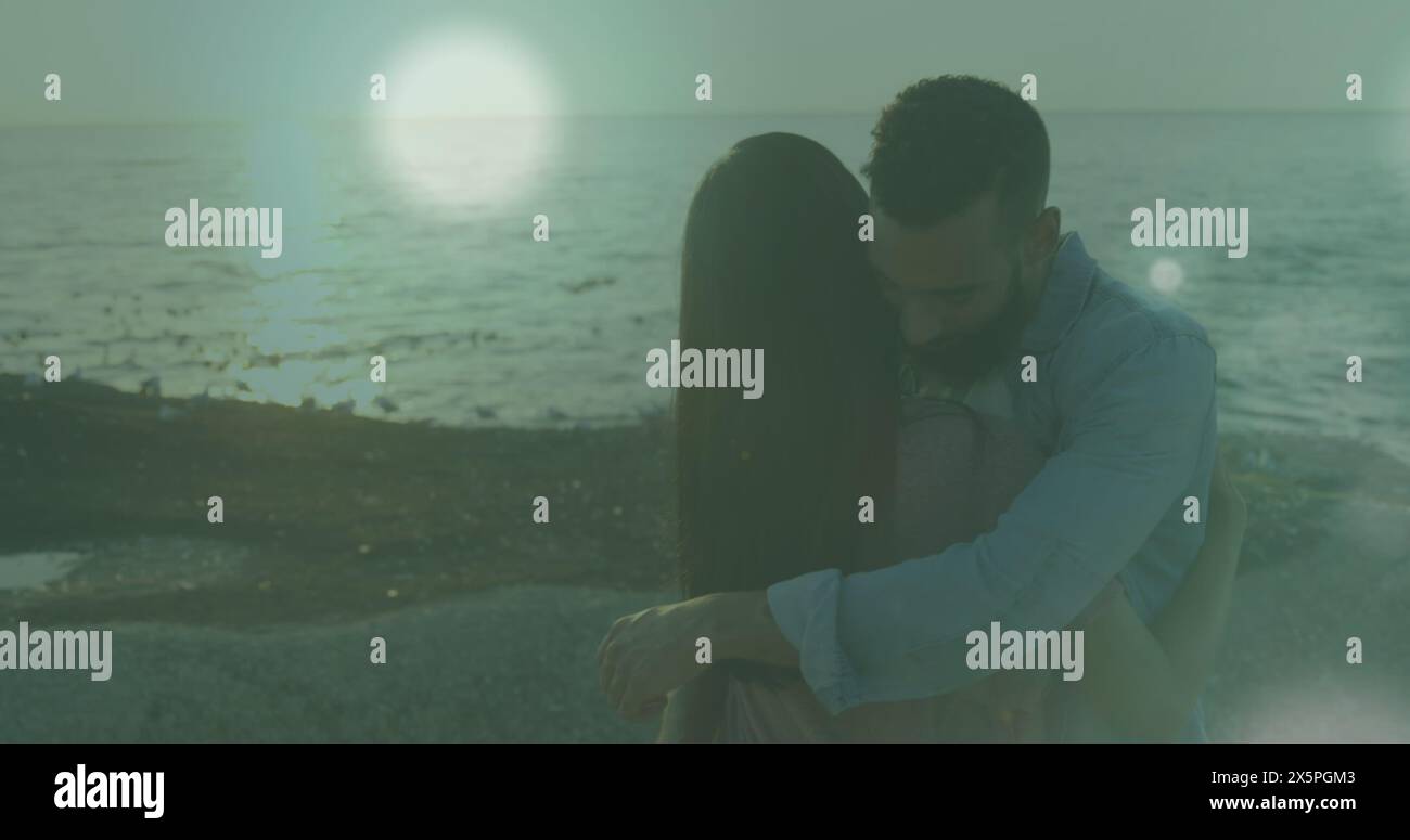 Image of spots of light against african american couple hugging each ...