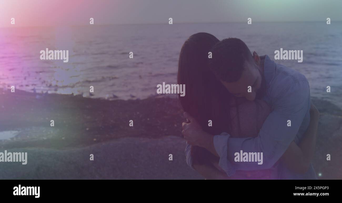 Image of spots of light against african american couple hugging each ...