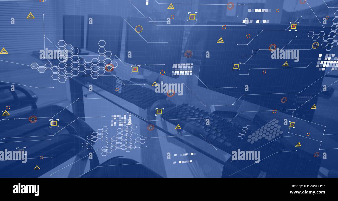 Data processing over computers on desks in empty office Stock Photo