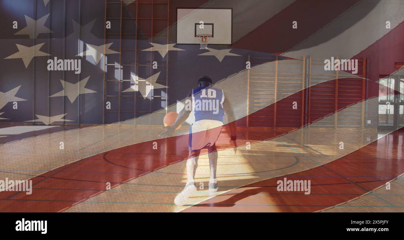 Middle-aged African American man in jersey dribbles basketball Stock Photo