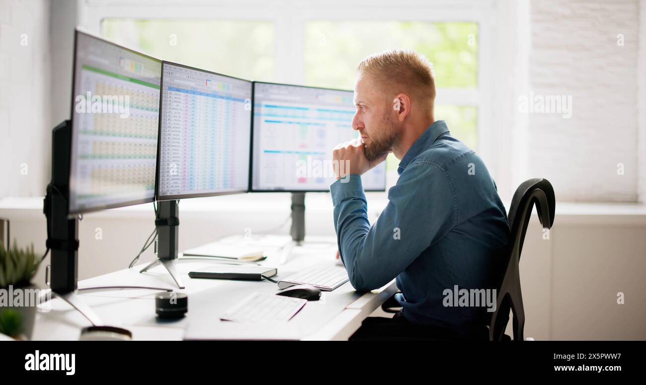 Data Analyst Man Using Spreadsheet On Computer Stock Photo