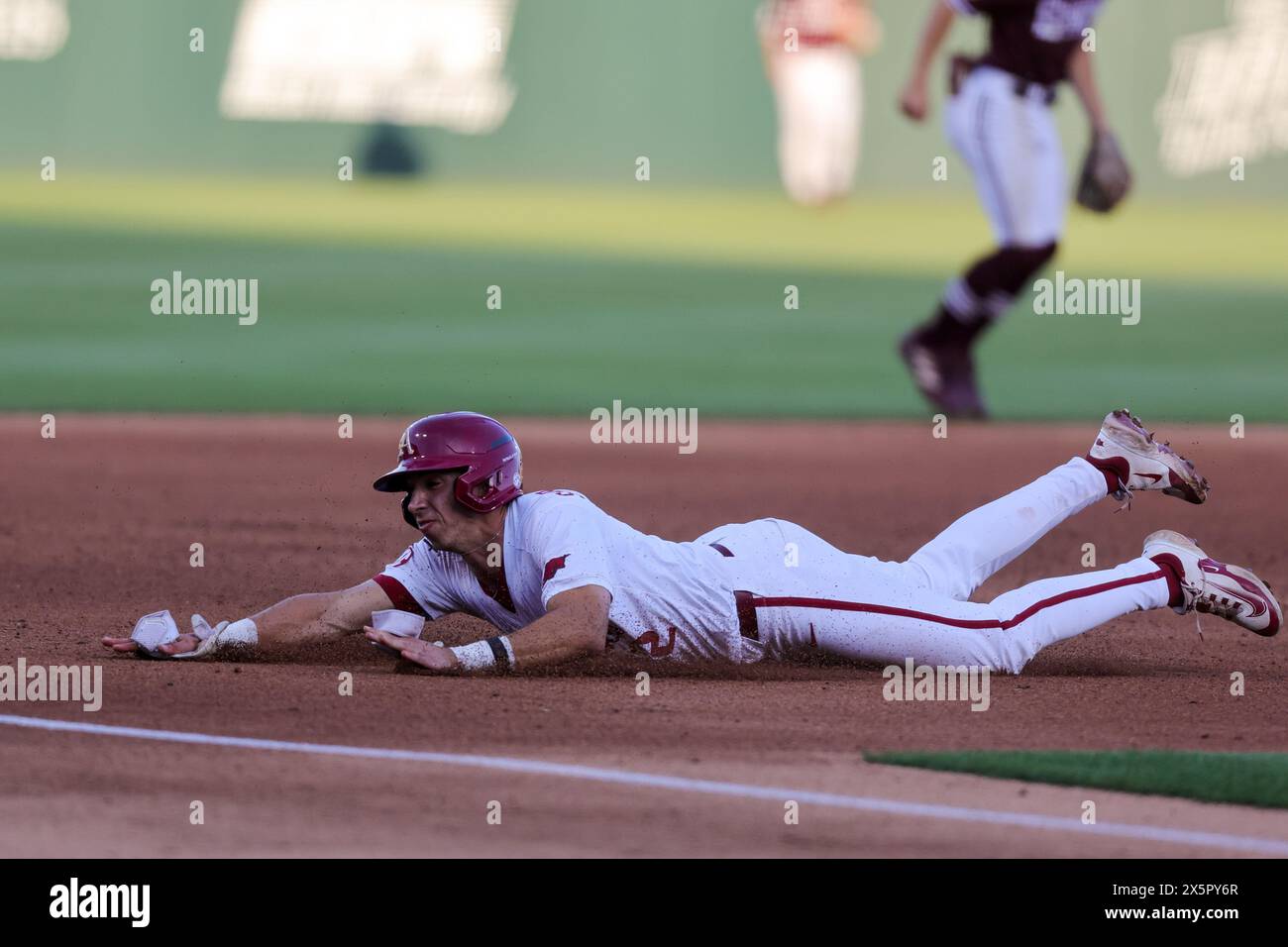 May 10, 2024: Jared Sprague-Lott #12 of Arkansas slides head first into third base. Arkansas defeated Mississippi State 7-5 in Fayetteville, AR. Richey Miller/CSM Stock Photo