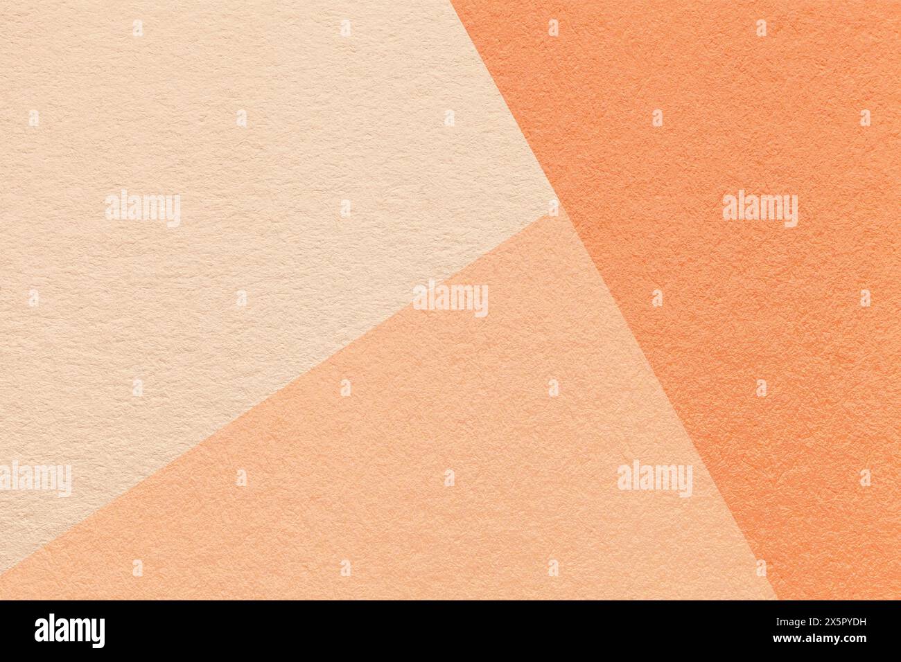 Color of year 2024. Texture of craft peach fuzz, beige and coral shade color paper background, macro. Structure of vintage abstract cardboard with geo Stock Photo