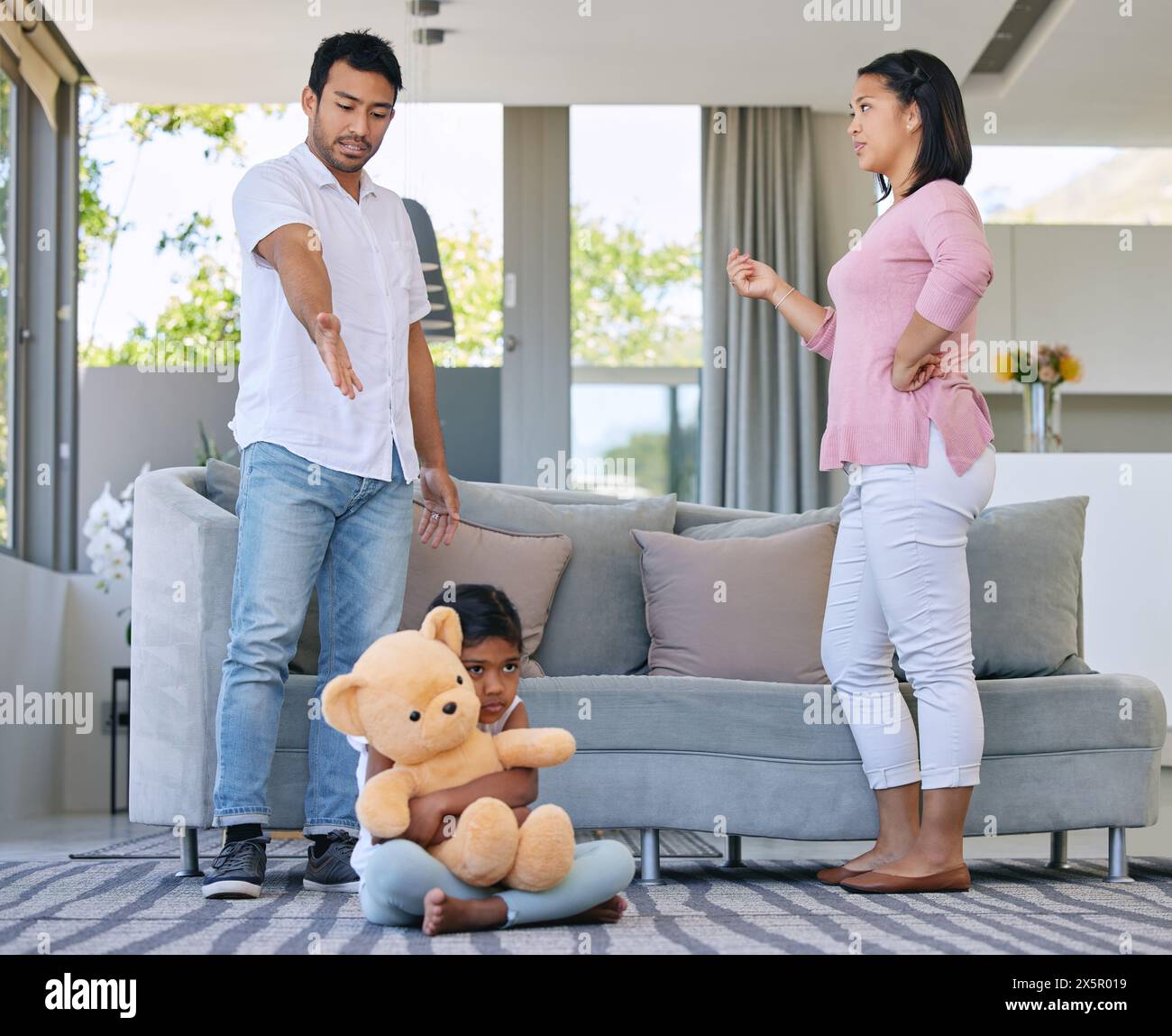 Parents, conflict and child with bear, anxiety and hug for support and